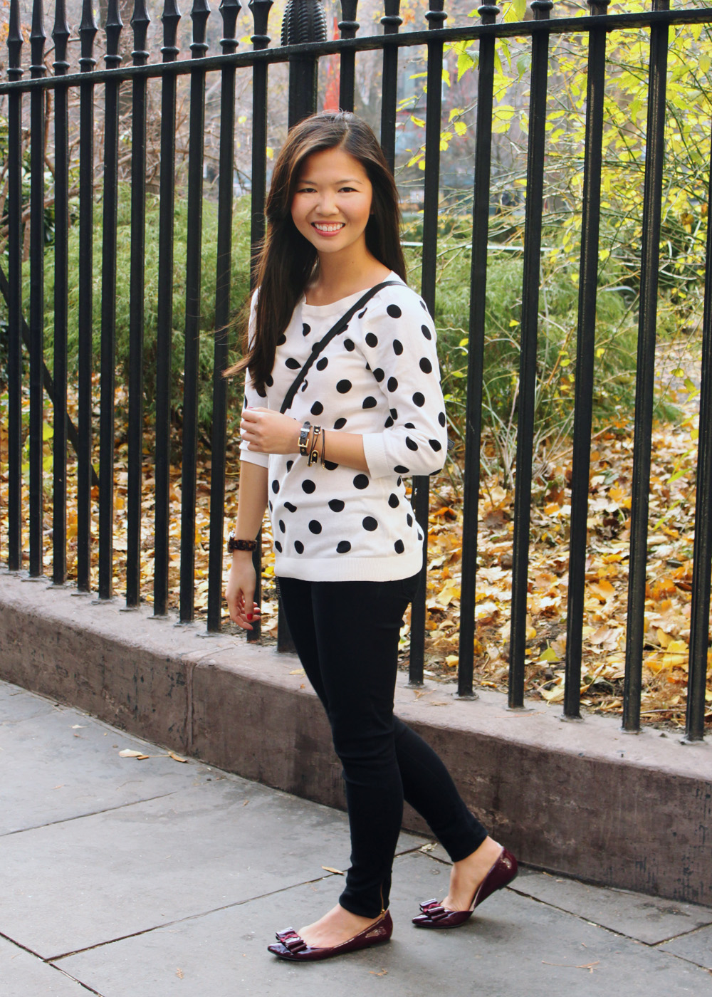 Jenny in Jacquard; NYC fashion blogger; style blog; outfit photos; Old Navy black and white polka dot sweater; Zara black skinny jeggings; Kate Spade black and white striped Scout crossbody bag; KTownsend Etsy black and gold bangles; ShoeMint Hilary bow flat in oxblood; Michael Kors tortoise gold boyfriend watch