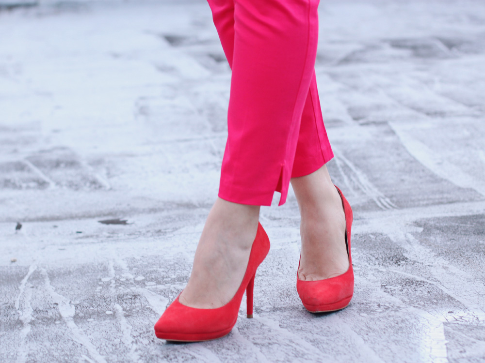 Skirt The Rules Blog; NYC fashion blogger; style blog; pink and red outfit photo; H&M black and white spot shirt; H&M hot pink capri pants; Spike The Punch Addison rhinestone statement necklace; Botkier Howard black satchel; A Beautiful Heart bubblegum black stretch bracelet; Pour La Victoire red suede pumps