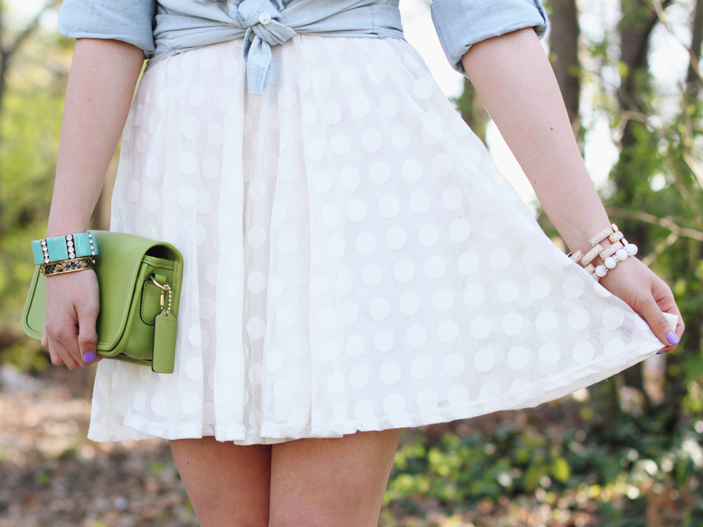 Skirt The Rules Blog; NYC fashion blogger; style blog; spring outfit photo; J.Crew Factory chambray shirt; Lulu's white polka dot dress; BaubleBar pink tab necklace; Coach Penny crossbody bag in lime green; J.Crew pave square link bracelet; J.Crew turquoise stretch bracelet; C. Wonder snakeskin bangle; Essie Play Date purple nail polish; Rosegold nude cut out heels