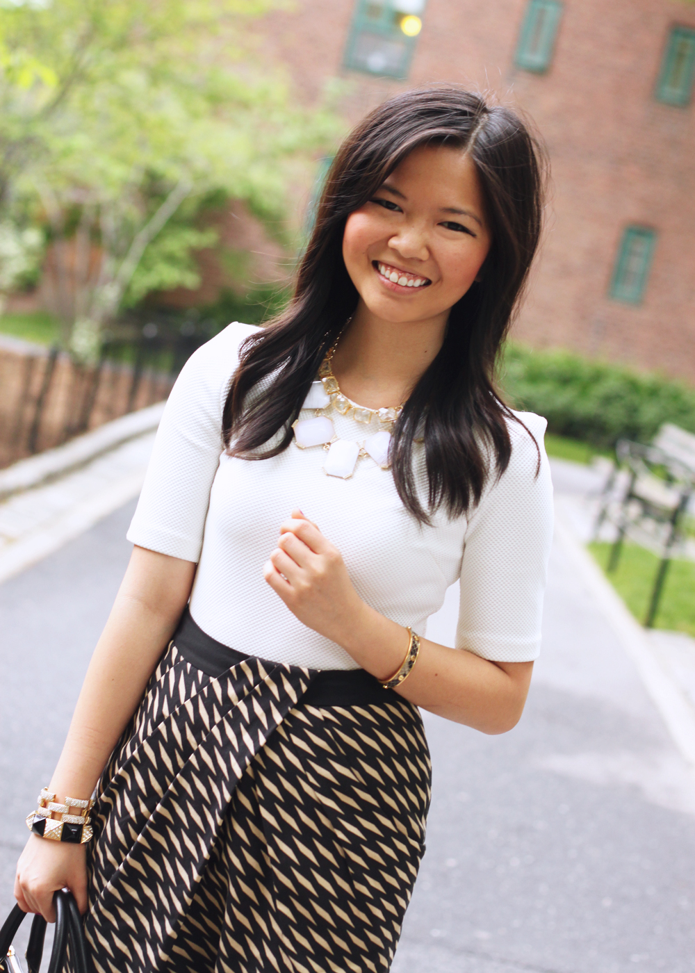Skirt The Rules Blog; NYC fashion blogger; style blog; spring outfit photo; H&M cream structured shoulder top; Modcloth geometric printed skirt; Tory Burch Robinson satchel tote; Banana Republic sparkle stone statement necklace; C. Wonder crystal gold necklace; C. Wonder snake skinny cuff; Juicy Couture pave pyramid stretch bracelet; J.Crew pave square link bracelet