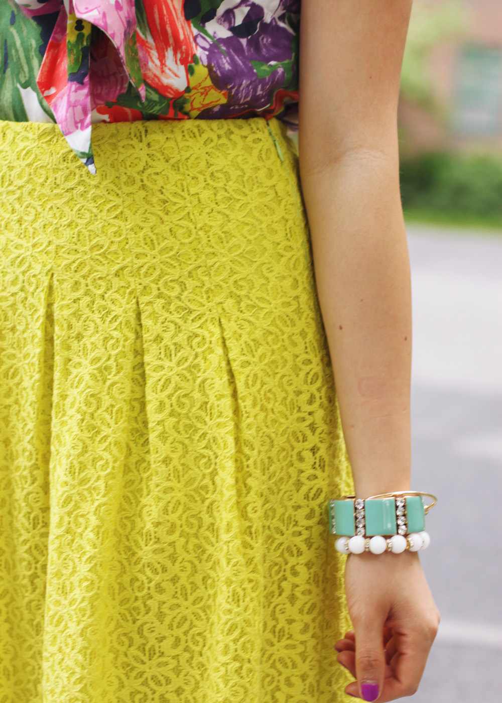 Skirt The Rules Blog; NYC fashion blogger; style blog; spring outfit photo; J.Crew floral print pussybow blouse; Anthropologie neon chartreuse lace skirt; J.Crew Factory neon rose clutch; J.Crew turquoise stretch bracelet; A Beautiful Heart white bubblegum bracelet; BaubleBar arrow cuff; Michael Kors gold boyfriend watch; Sam Edelman colorblock wedge; Essie DJ Play That Song neon purple nail polish