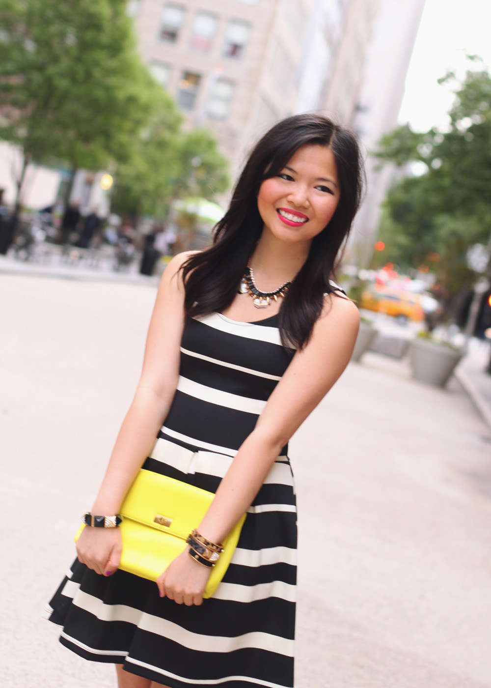 Skirt The Rules Blog; NYC fashion blogger; style blog; spring outfit photo; black and white striped dress; J.Crew Factory Vero neon yellow clutch; ShoeMint hot pink pointed pumps; Juicy Couture pave pyramid stretch bracelet; C. Wonder skinny bangles; Crown and Glitter black and gold spike necklace; BaubleBar bronze geometric necklace