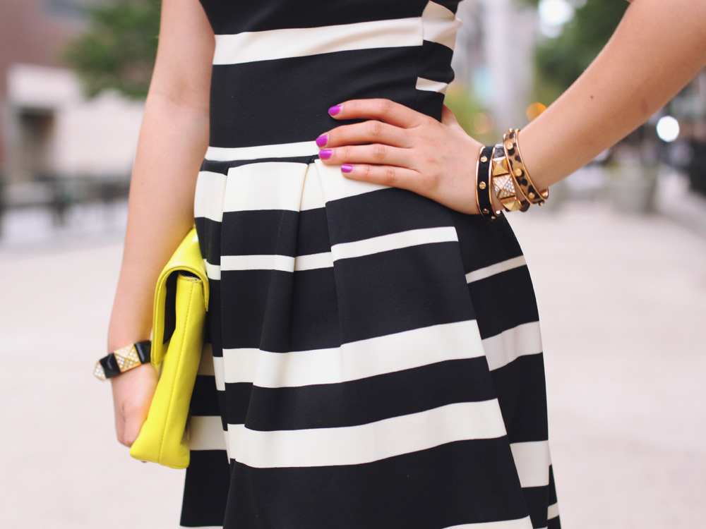 Skirt The Rules Blog; NYC fashion blogger; style blog; spring outfit photo; black and white striped dress; J.Crew Factory Vero neon yellow clutch; ShoeMint hot pink pointed pumps; Juicy Couture pave pyramid stretch bracelet; C. Wonder skinny bangles; Crown and Glitter black and gold spike necklace; BaubleBar bronze geometric necklace