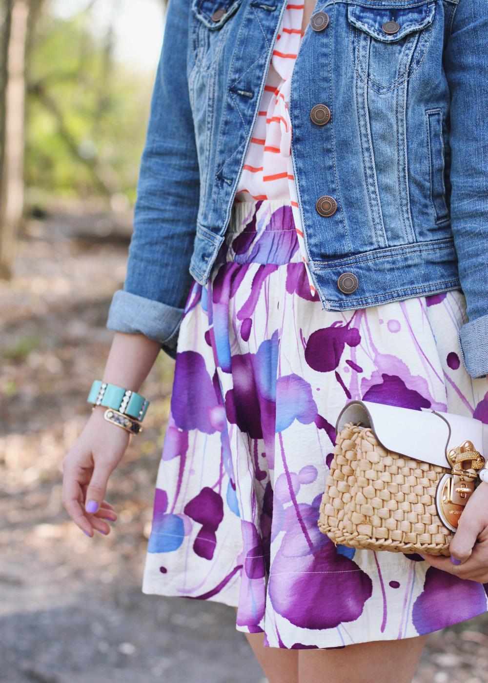 Skirt The Rules Blog; NYC fashion blogger; style blog; spring outfit photo; Banana Republic Factory striped pussybow blouse; Forever 21 floral water color skirt; American Eagle denim jacket; Michael Kors straw clutch; J.Crew turquoise stretch bracelet; A Beautiful Heart bubblegum bracelet; J.Crew pave square link bracelet; Sam Edelman colorblock wedge