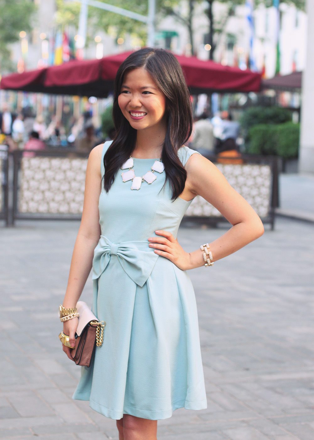 Skirt The Rules Blog; NYC fashion blogger; style blog; feminine outfit photos; Hello Glam Prim and Proper blue bow dress; Banana Republic sparkle stone white statement necklace; Linea Pelle Grayson Bar Clutch in blus; J.Crew pave square link bracelet; Michael Kors gold boyfriend watch; Brighthouse Baubles gold chain bracelet; Pour La Victoire Mai wedge pump