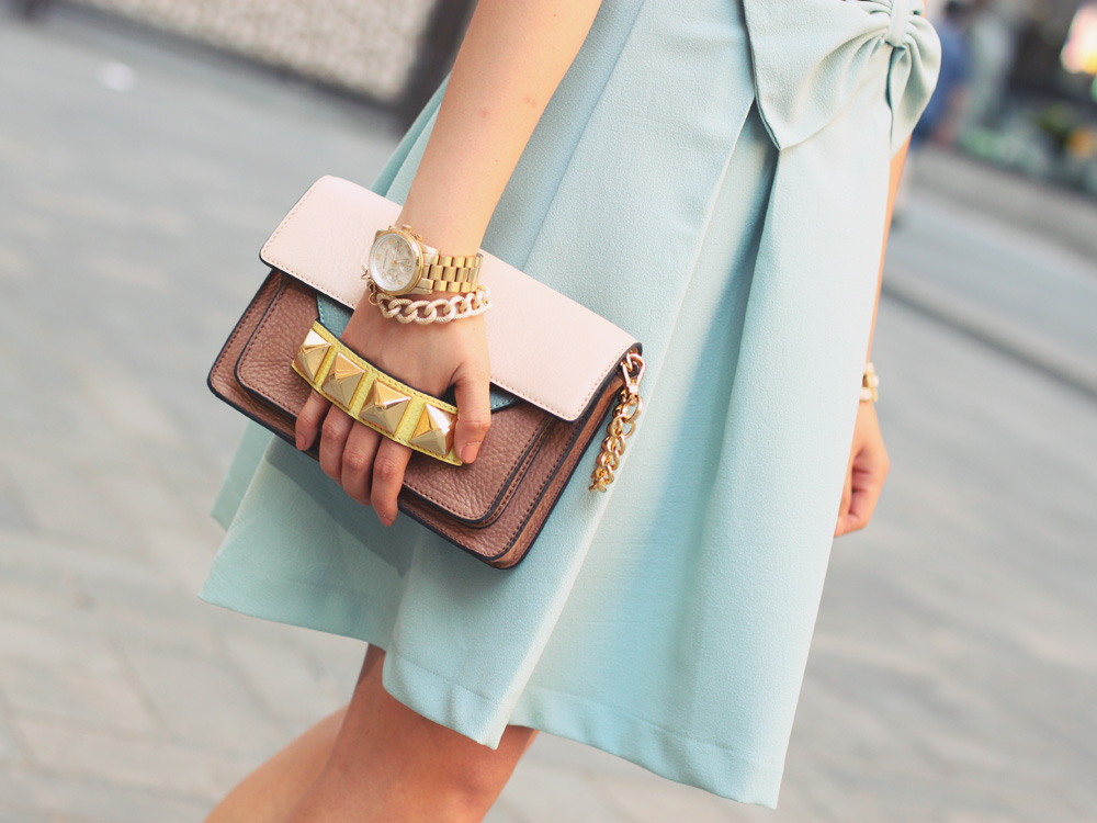 Skirt The Rules Blog; NYC fashion blogger; style blog; feminine outfit photos; Hello Glam Prim and Proper blue bow dress; Banana Republic sparkle stone white statement necklace; Linea Pelle Grayson Bar Clutch in blus; J.Crew pave square link bracelet; Michael Kors gold boyfriend watch; Brighthouse Baubles gold chain bracelet; Pour La Victoire Mai wedge pump