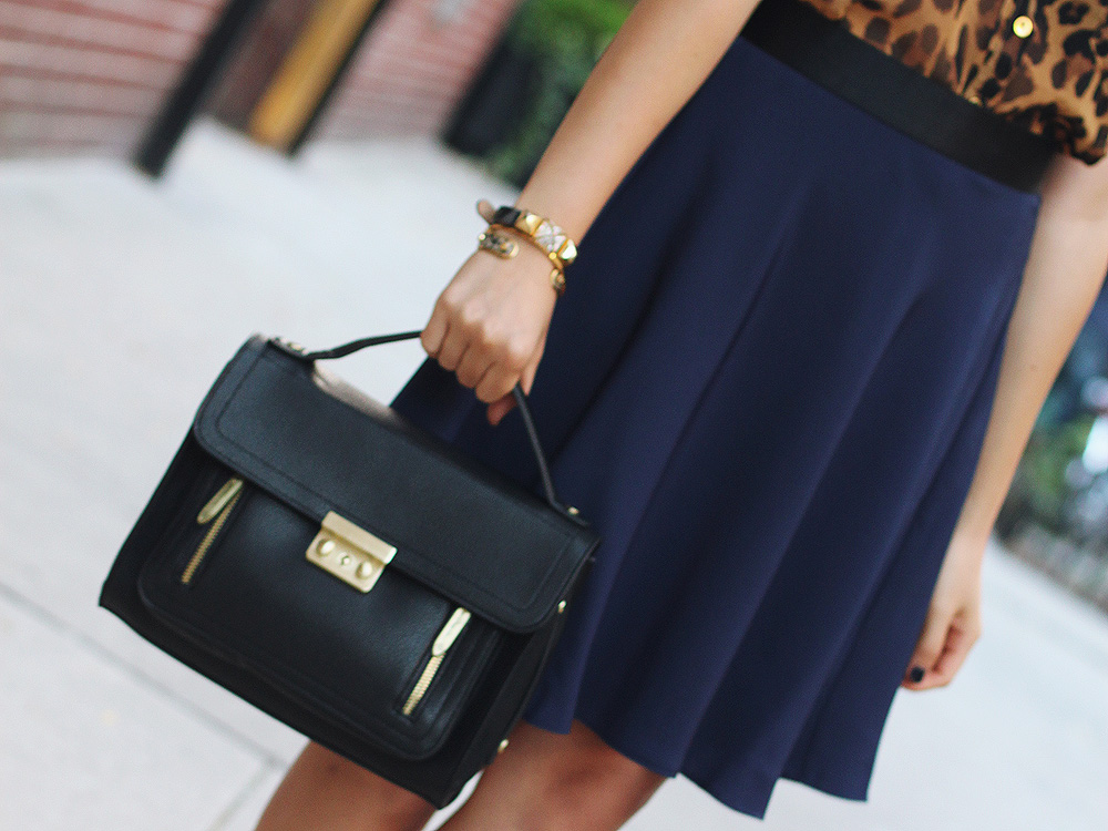 Skirt The Rules Blog; NYC fashion blogger; style blog; fall outfit photo; leopard sleeveless blouse; 3.1 Phillip Lim x Target navy skirt; 3.1 Phillip Lim black satchel; C. Wonder tortoise link necklace; C. Wonder snakeskin skinny bangle; Gorjana & Griffin alphabet disc bracelet; Juicy Couture pave pyramid bracelet; Pour La Victoire Mai patent black wedge pumps