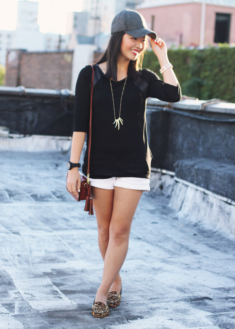 Skirt The Rules Blog; NYC fashion blogger; style blog; fall outfit photo; how to wear a baseball cap; Zara black leather panel top; Hollister white shorts; Sequin gold talon necklace;  Coach Legacy brown crossbody bag; Movado Esq One black silicone unisex watch; Joie Dylan leopard loafers; Essie white nail polish