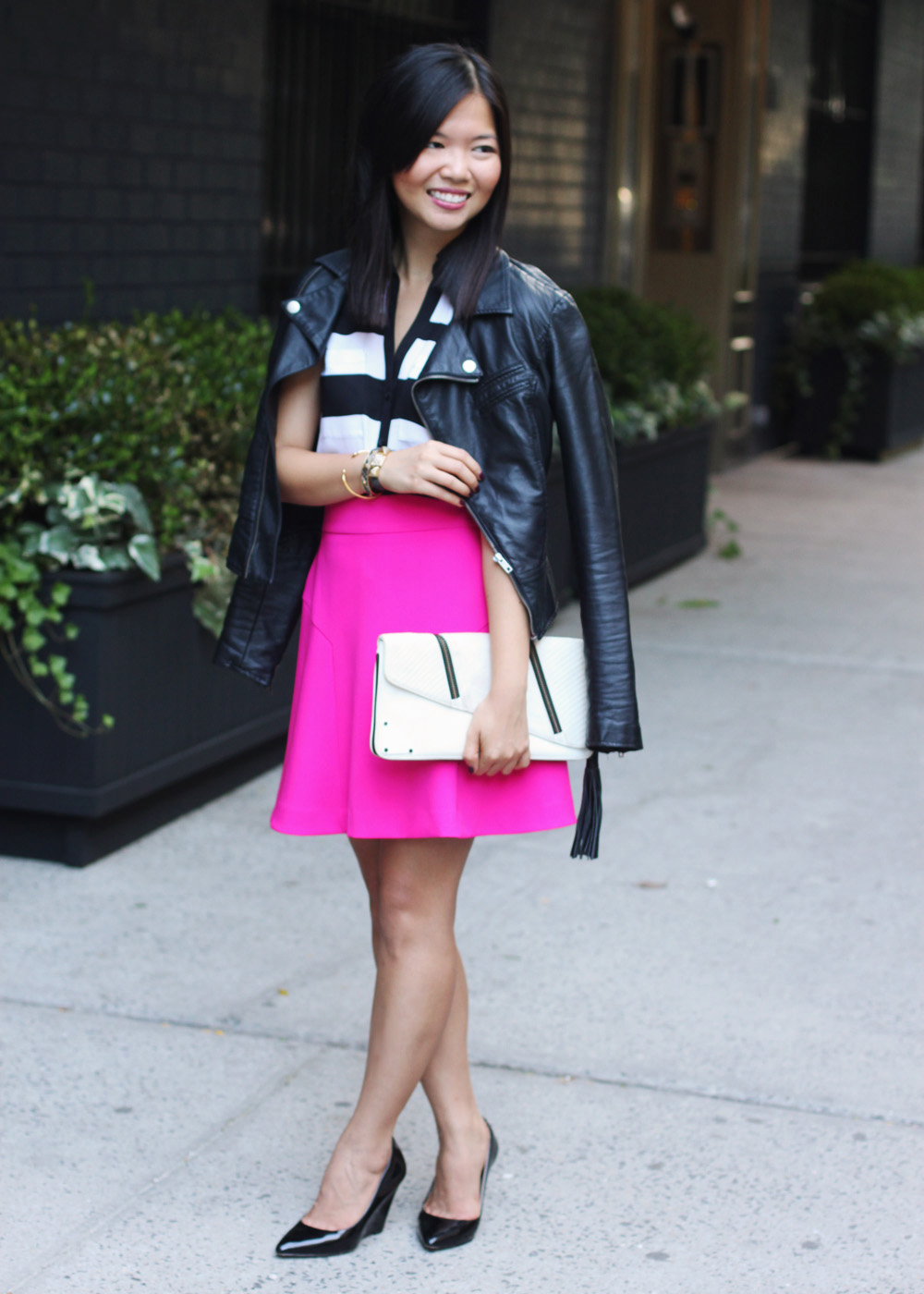 Skirt The Rules Blog; NYC fashion blogger; style blog; fall outfit photo; Express Wide Stripe Sleeveless Portofino Shirt; Express hot pink a-line skirt; faux leather biker jacket; LAMB black and white clutch; Pour La Victoire Mai black patent wedges; Juicy Couture pave pyramid leather bracelet; C. Wonder snakeskin skinny bracelet; Gorjana & Griffin alphabet disc bracelet cuff