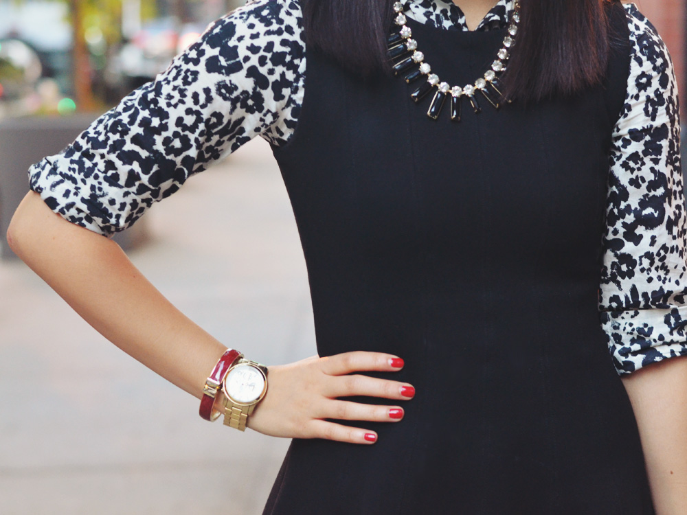 Skirt The Rules Blog; NYC fashion blogger; how to style a little black dress; how to wear a shirt under a dress; Zara black a-line skater skirt; J.Crew black and white snow leopard button up shirt; T&J Designs black statement necklace; Lipstick Rose Red Riding oxblood bangle bracelet; Michael Kors gold mother of pearl face boyfriend watch; Pour La Victoire Mai black patent wedge pumps; Olivia & Joy Rockefeller red satchel