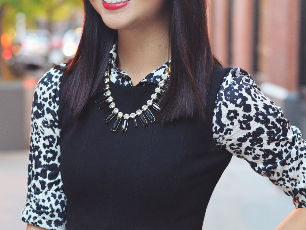 Skirt The Rules Blog; NYC fashion blogger; how to style a little black dress; how to wear a shirt under a dress; Zara black a-line skater skirt; J.Crew black and white snow leopard button up shirt; T&J Designs black statement necklace; Lipstick Rose Red Riding oxblood bangle bracelet; Michael Kors gold mother of pearl face boyfriend watch; Pour La Victoire Mai black patent wedge pumps; Olivia & Joy Rockefeller red satchel