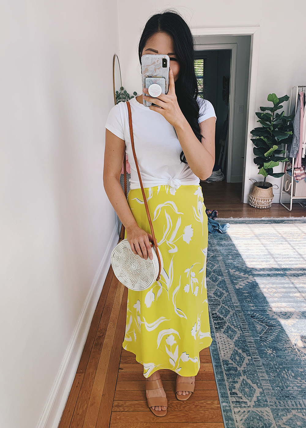 Casual Spring Outfit: White Knotted T-Shirt, Bright Yellow Floral Midi Skirt, White Straw Circle Bag